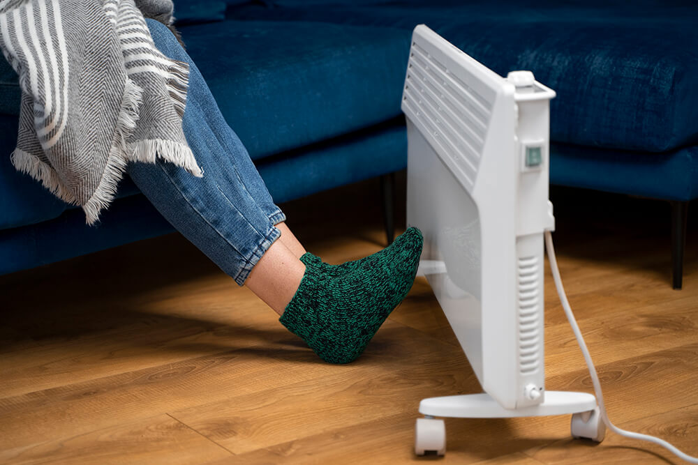 close-up-feet-getting-warm-near-heater