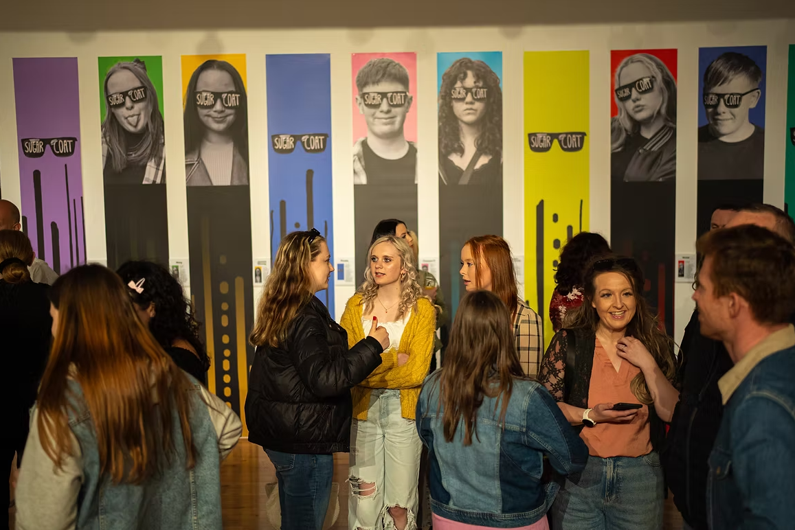 Sugarcoat participants presenting their exhibition