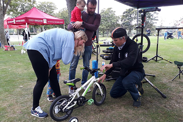 man fixing child's bike