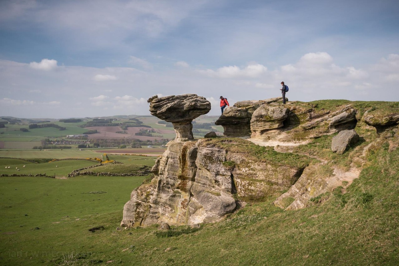 Two people hiking through outdoor areas in Fife