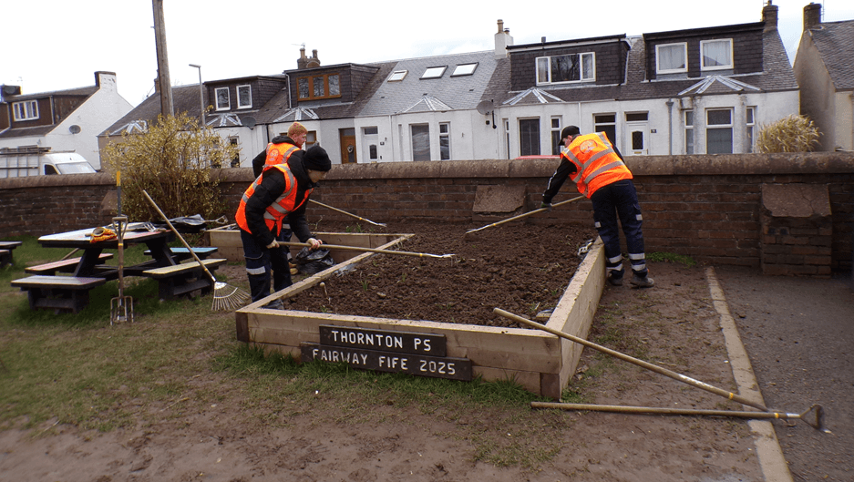 Members of the TurnAround programme planting a community flower bed